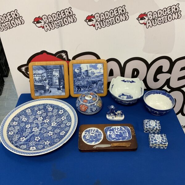 Collection of antique Chinese blue and white ceramics on blue background.