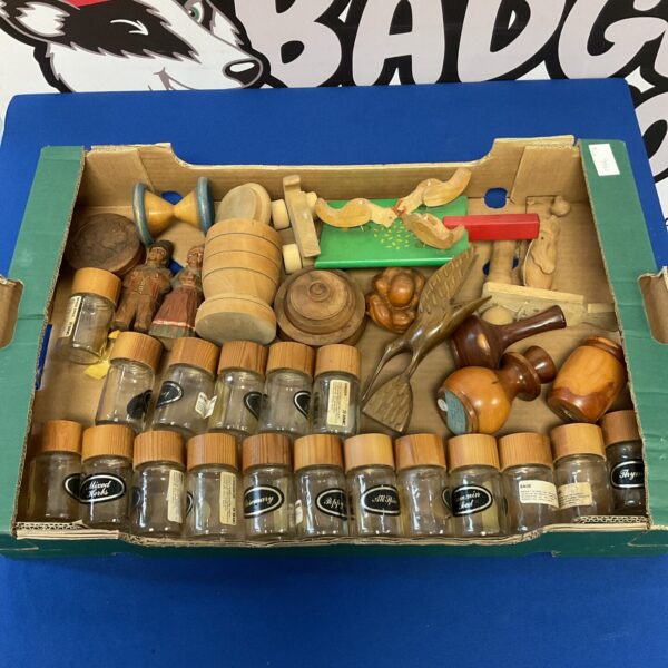 Vintage spice jars and wooden figures in a collectible lot.