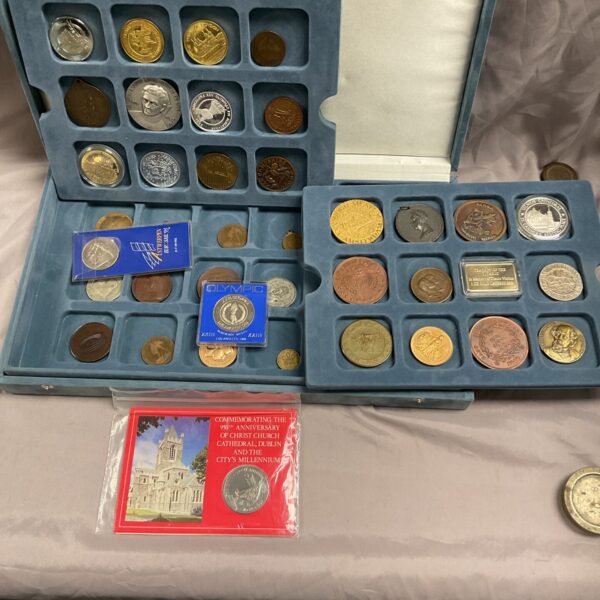 Overview of a commemorative coin and medal collection in a presentation case.