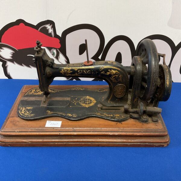 Antique Singer sewing machine with decorative floral details.