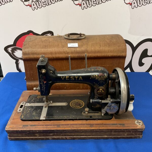Vintage Vesta sewing machine with hand crank mechanism.
