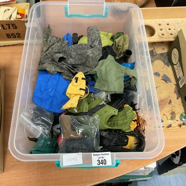 Vintage Action Man clothing lot with various outfits and accessories.