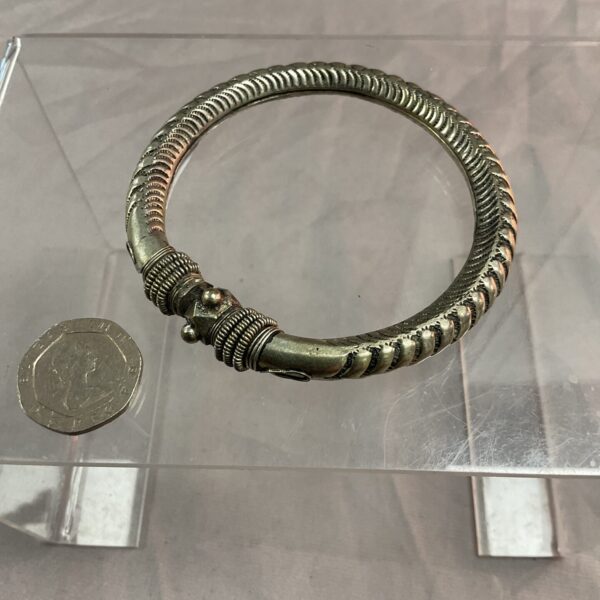 Antique Indian silver bracelet with intricate tribal designs.
