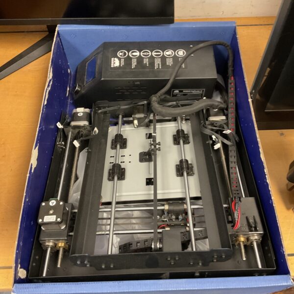 Disassembled Wanhao 3D printer with components visible inside packaging.