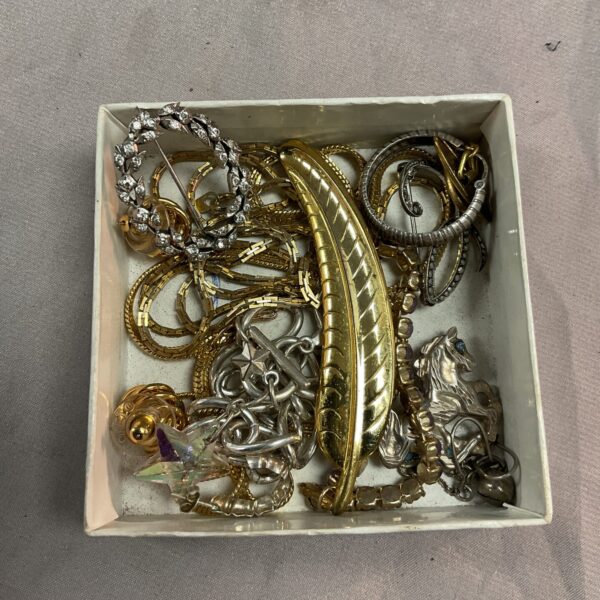 Vintage costume jewellery lot with yellow and white metal pieces.