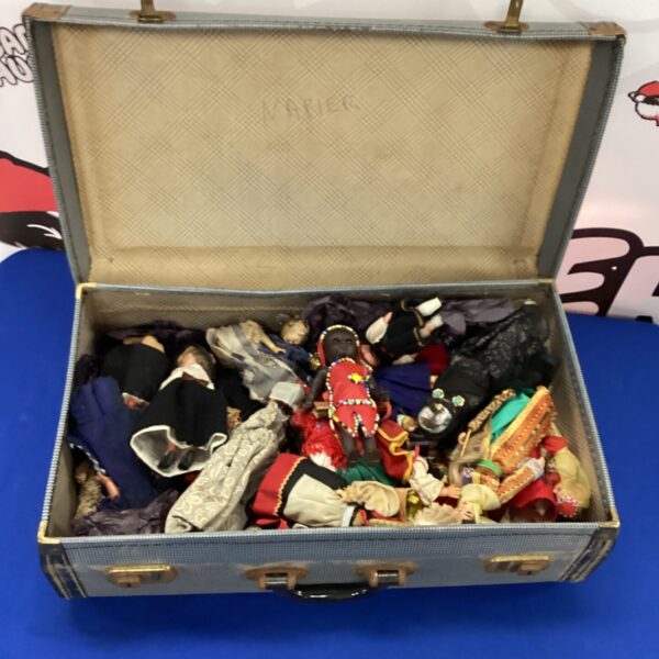 Vintage suitcase filled with a diverse lot of collectable dolls.