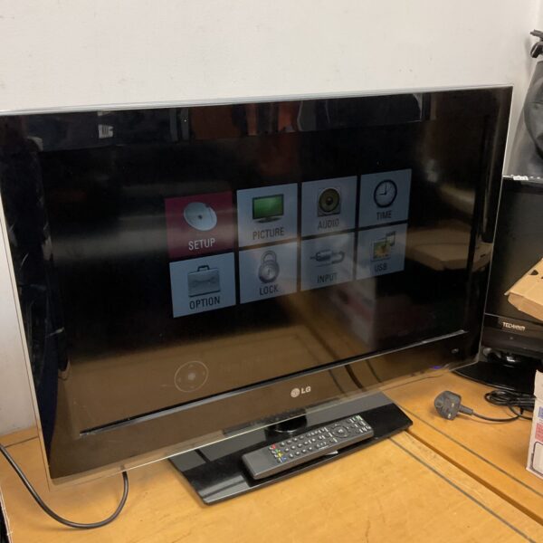 LG 32 inch HD television with remote control displayed.
