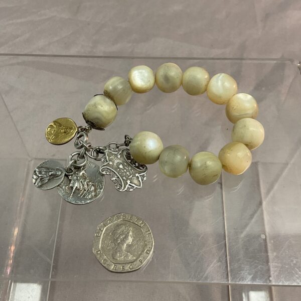 Vintage mother of pearl bracelet with four religious charms.