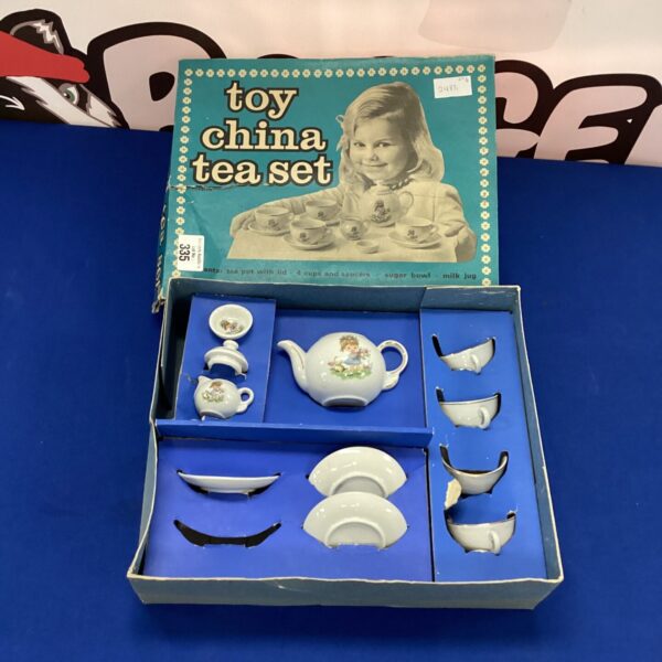 Vintage toy china tea set with floral patterns.