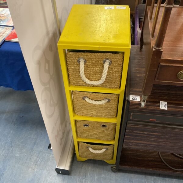 Bright yellow wicker storage unit with four drawers.