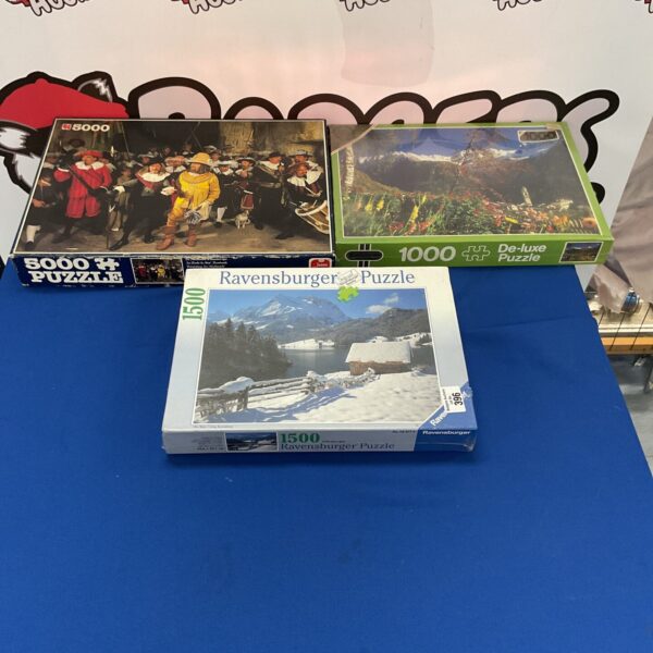 Sealed Ravensburger and Falcon jigsaw puzzle lot for collectors.