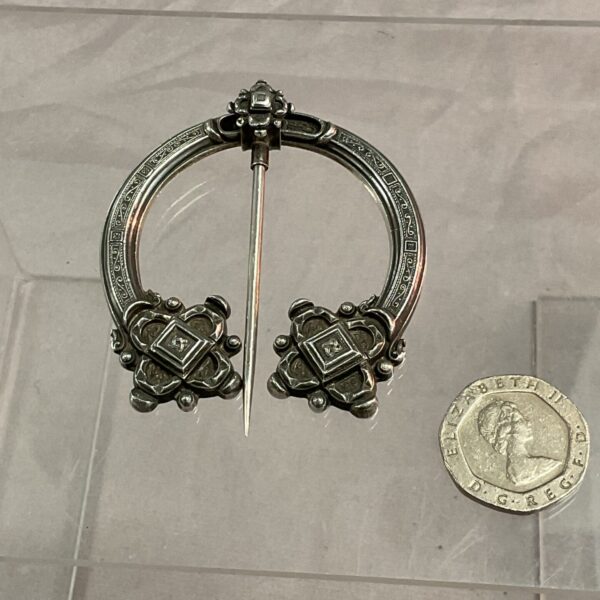 Antique Scottish kilt pin with Celtic knotwork detailing.