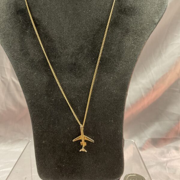 Close-up of vintage VC10 pendant necklace, aviation jewellery.