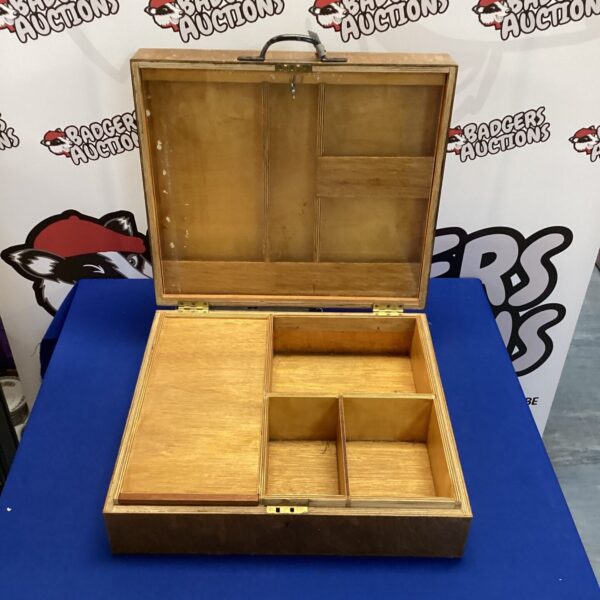 Vintage wooden artist case with hinged lid for art display.