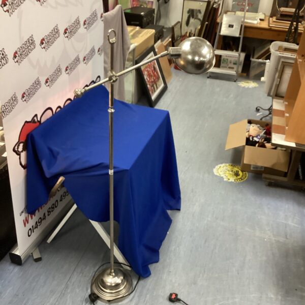 Vintage adjustable floor lamp with brushed steel finish.