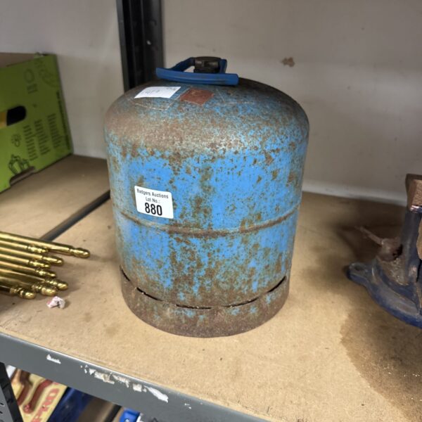 Blue vintage Camping Gaz bottle with signs of wear.