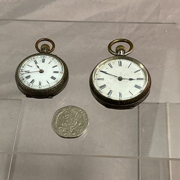 Two silver ladies pocket watches with white enamel dials.