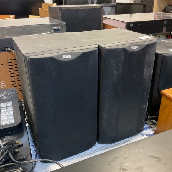 Pair of vintage Bowers & Wilkins DM601 bookshelf speakers in a home setting.