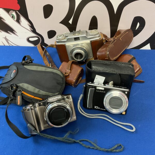 Vintage camera lot featuring Olympus and Lumix point and shoot cameras.