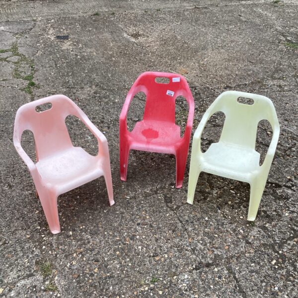 Three colourful vintage plastic chairs for children.