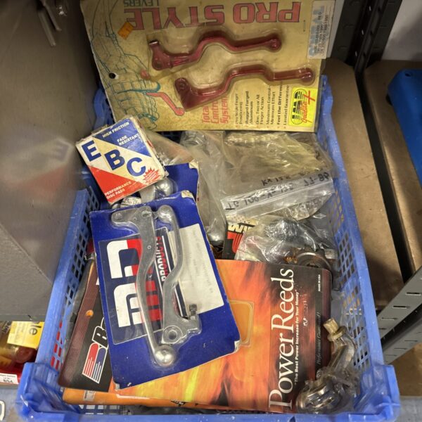 Tray of new old stock motorcycle handlebar levers and parts.