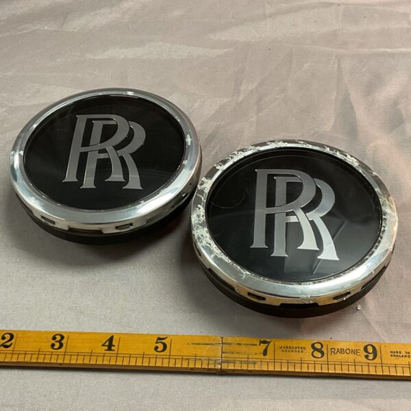 Pair of vintage Rolls Royce hub spinners with RR emblem.