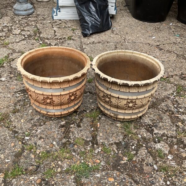 Two embossed plastic garden tubs for outdoor planting.