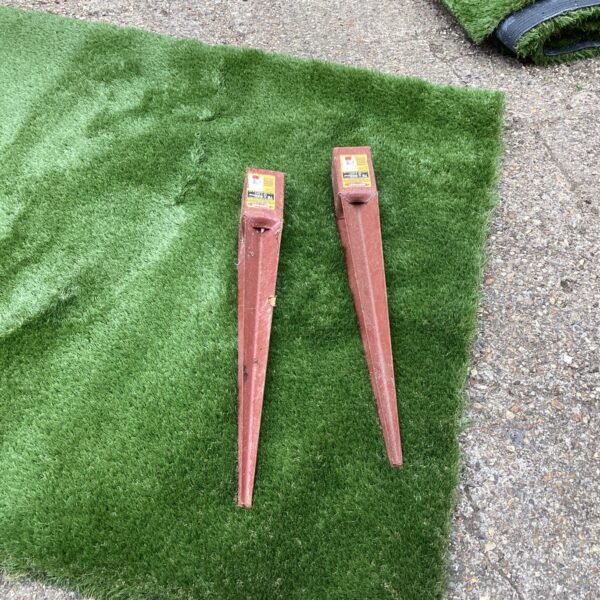 Pair of used Metpost fence post fixings for garden fencing.
