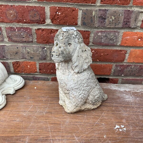 Vintage garden stone dog ornament for outdoor decoration.