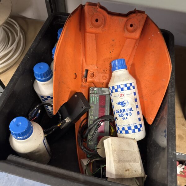 Vintage taxi fare meter and gear oil bottles in a lot.