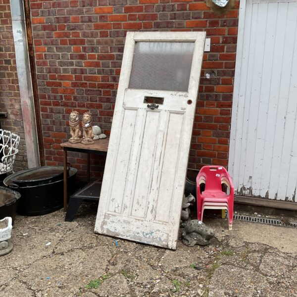 Vintage wooden door with glazed panels, ideal for restoration.
