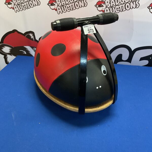 Red and black vintage ladybug ride on toy by Skipper Toys.