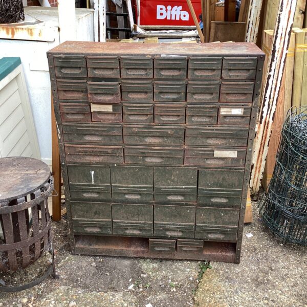 Vintage metal garage storage box with multiple drawers.