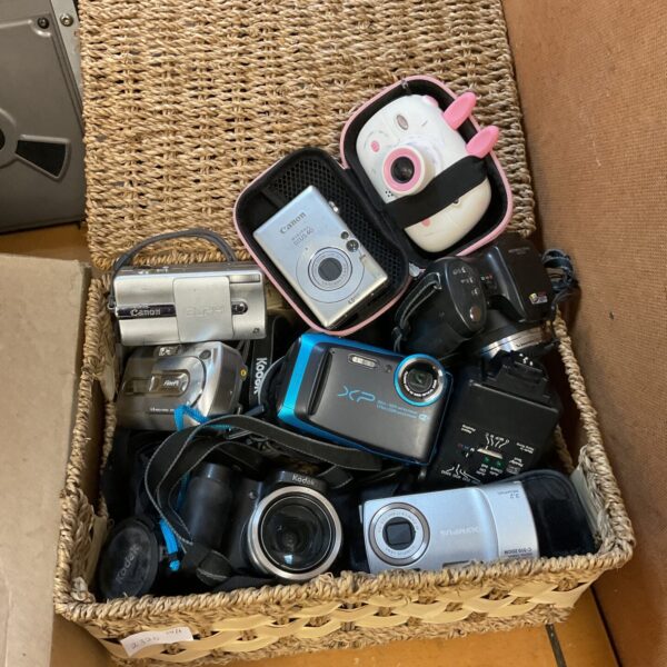 Digital camera lot including Canon and Olympus point and shoot cameras.