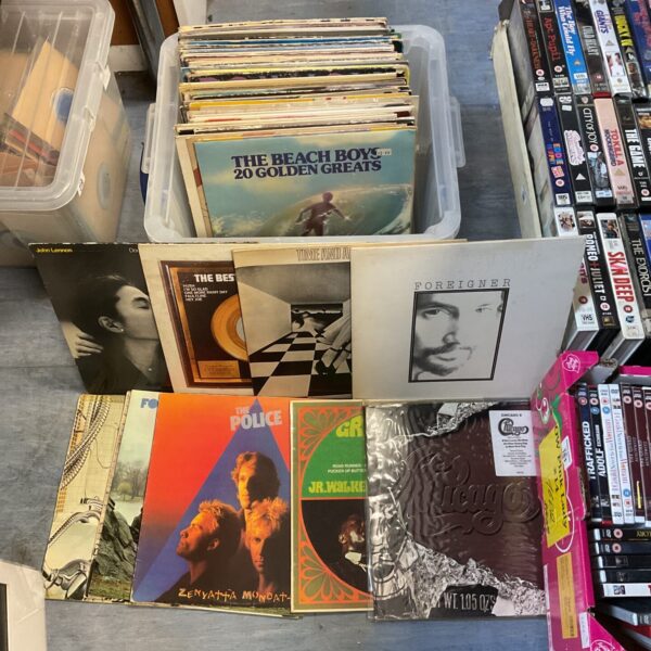 Vintage vinyl record collection including John Lennon and The Police.