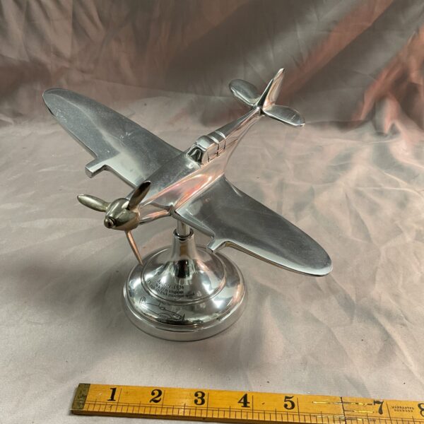 Detailed aluminium Spitfire model airplane on display.