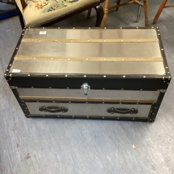 Vintage aluminium storage trunk with wooden accents and a single drawer.