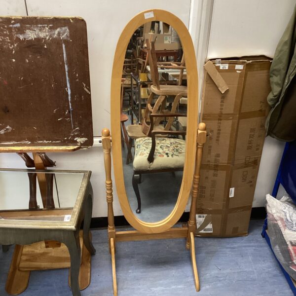 Full length beech effect bedroom mirror with oval shape.