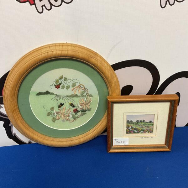 Vintage framed embroidery featuring a colourful floral design.