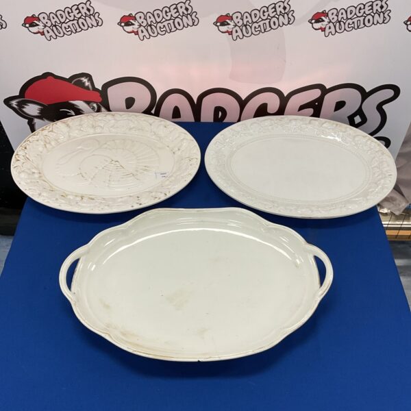Three large white porcelain serving platters for serving meat.