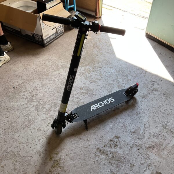 Side view of a used Archos electric scooter.