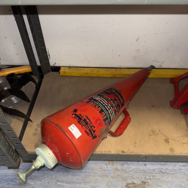 Vintage red Minimax conical fire extinguisher, antique firefighting equipment.