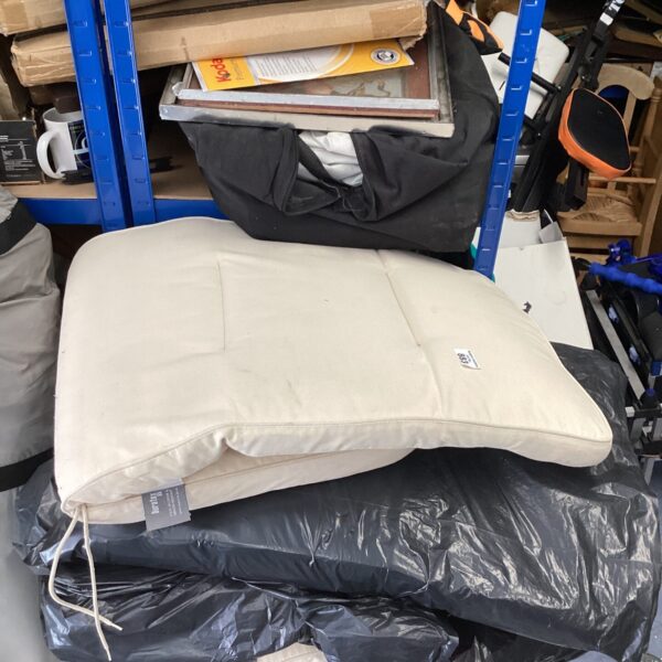 Set of four neutral patio chair cushions for outdoor comfort.