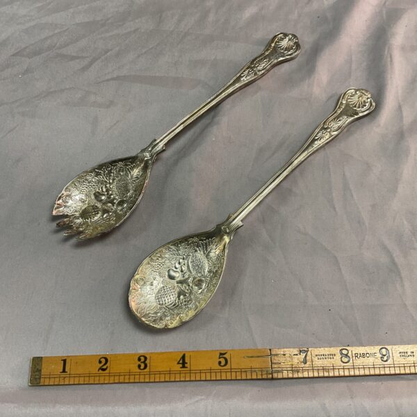 Antique silver Kings pattern berry spoons with ornate detailing.
