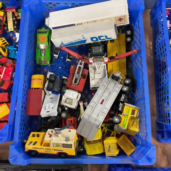 Vintage diecast model tray with mixed toy cars and trucks.