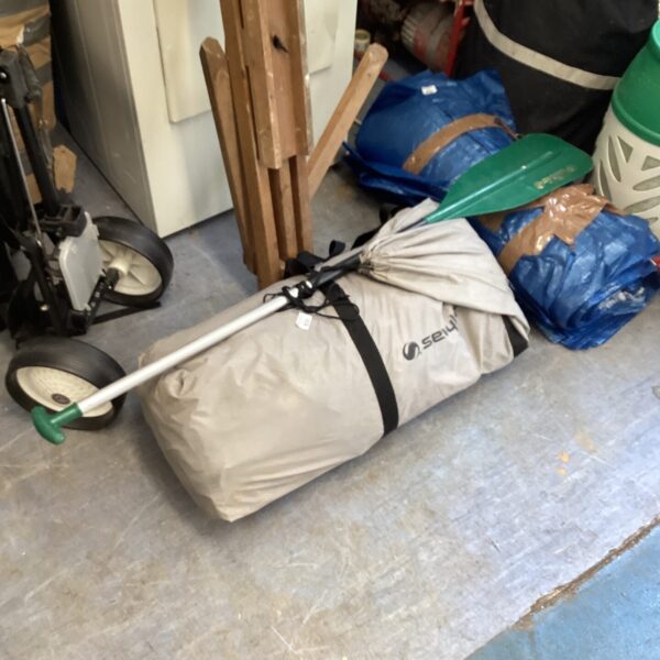 Sevylor inflatable canoe with paddle and carry bag for outdoor recreation.