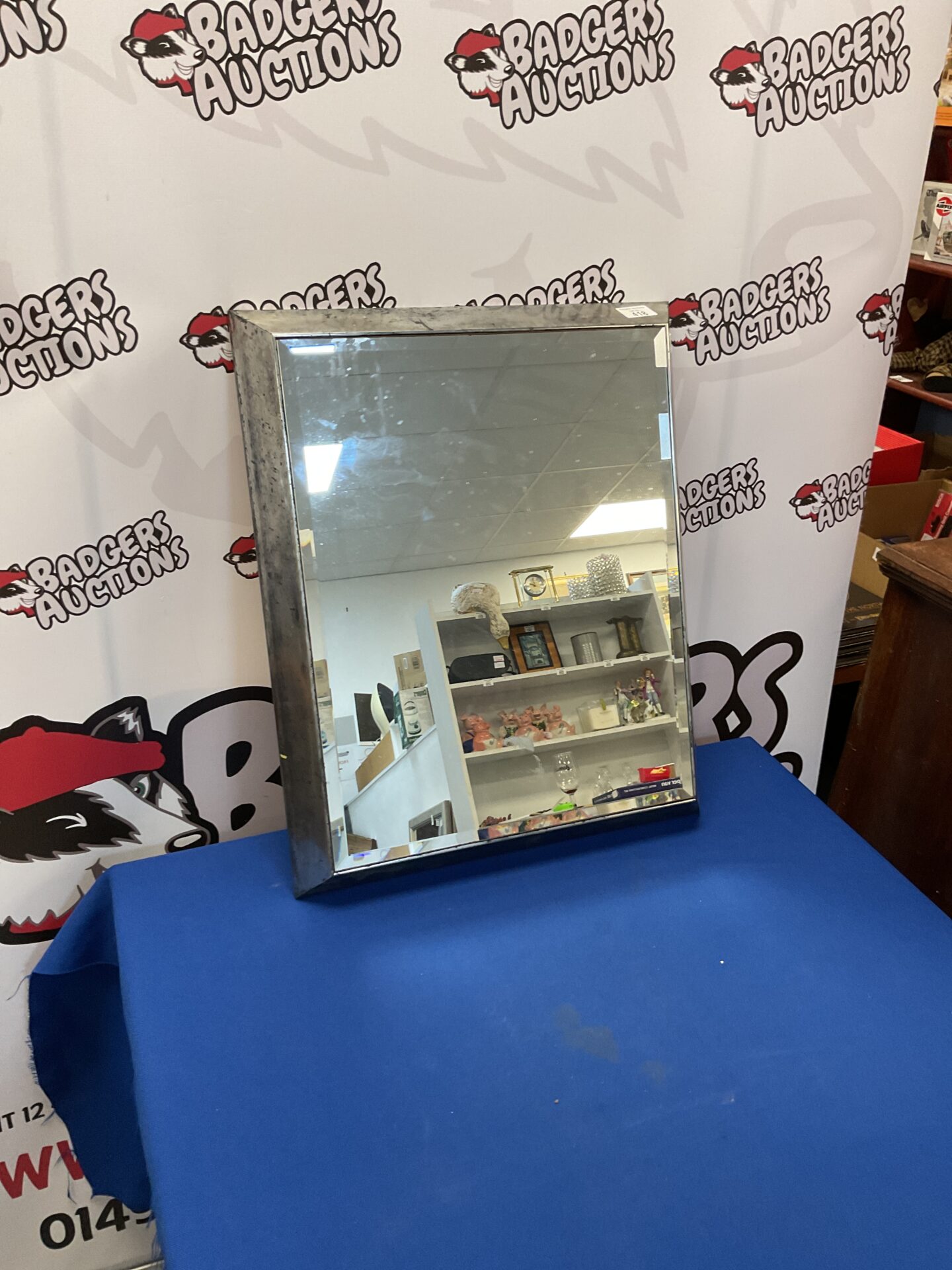 423 Small silver tone bevel edged mirror
