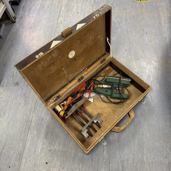 Vintage wooden toolbox filled with various tools and components.