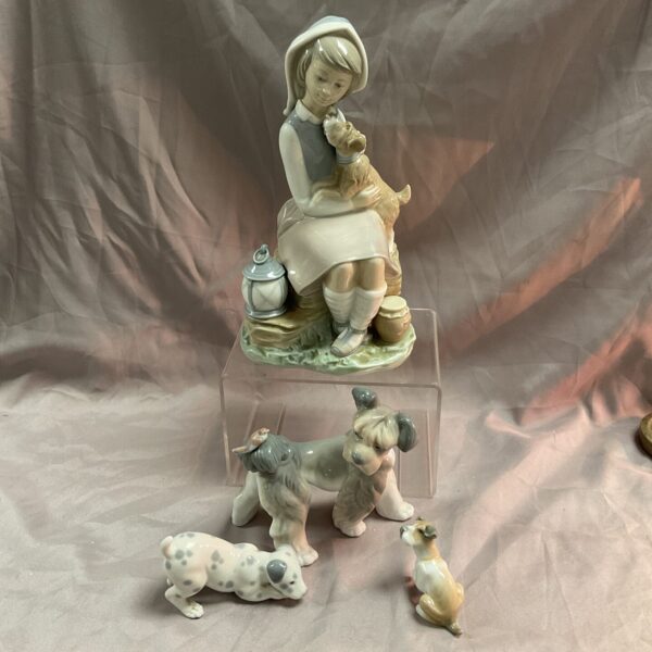Lladro porcelain figurine of a girl with dogs, detailed sculpture.