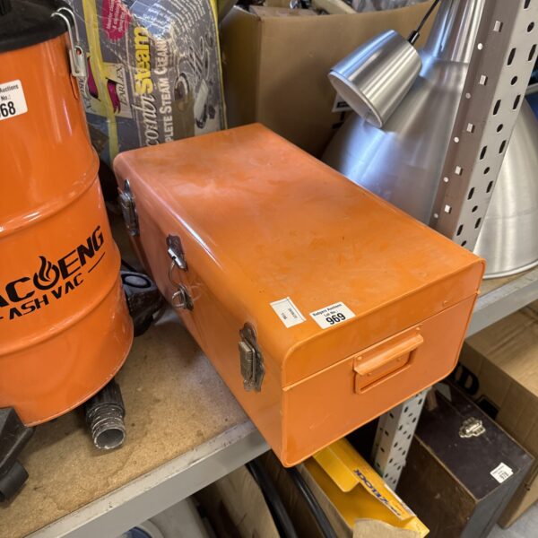 Vintage metal storage box with a latch and handle.